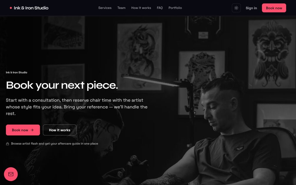The BookEase landing configured as a tattoo studio in the dark Nocturne theme: a full-bleed black-and-white photo of an artist at work, a nav reading Ink and Iron Studio, the headline Book your next piece, and a hot-pink Book now button beside How it works.